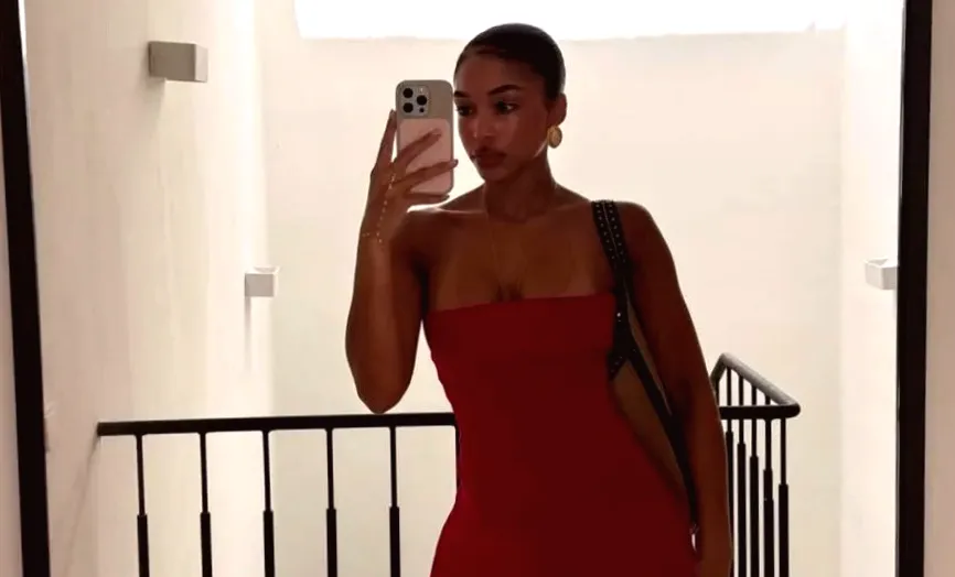 Photo shows Lori Harvey wearing a lace-heavy tiny sheer minidress