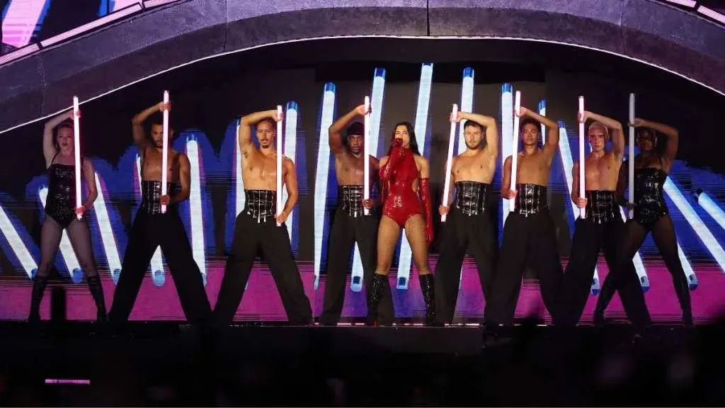 Dua Lipa's Courreges Bodysuit Features Waist Cutouts & Belts